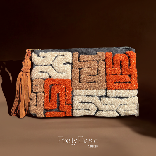 Kuba hand tufted clutch